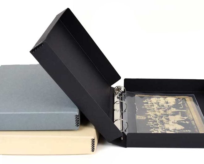 Archival Binder-in-box in black, tan, and gray. Black box open to reveal pocket pages with photos