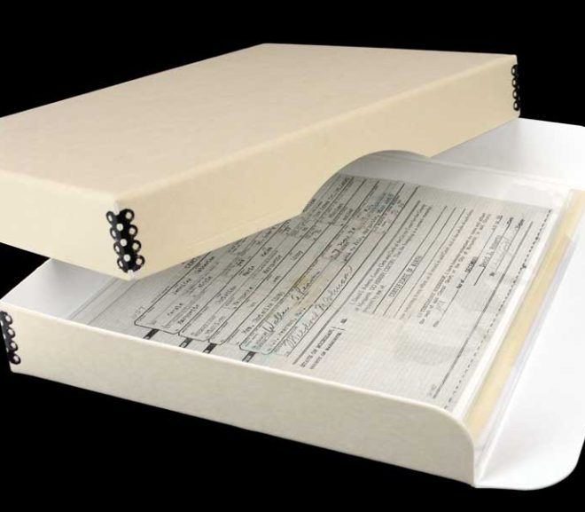 Acid-free tan metal edge box storing an old birth certificate