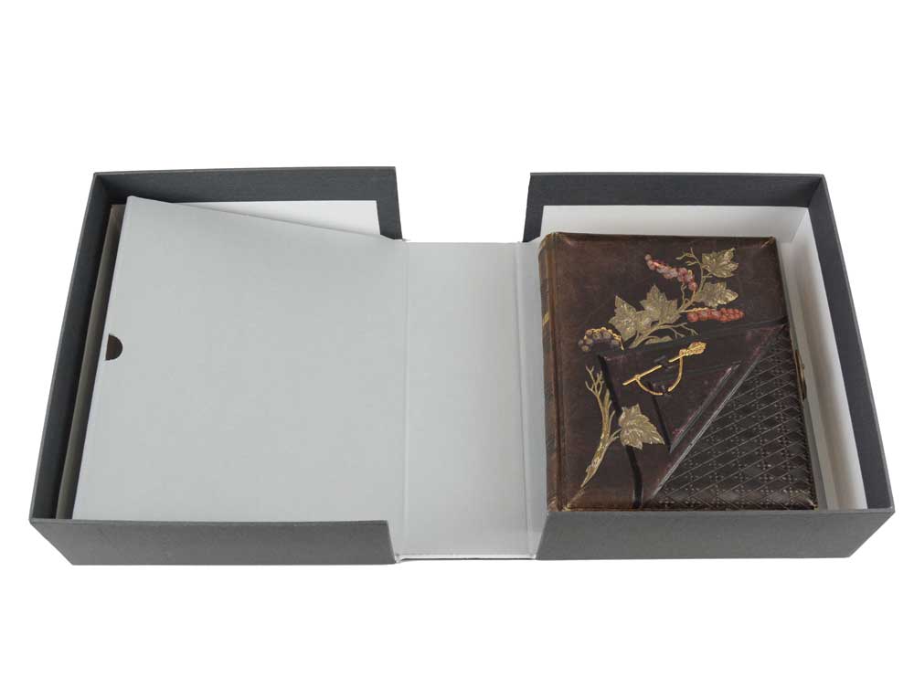 Rare Book Box with Cradle for fragile books, featuring a spine-supporting cradle holding a book in a durable archival storage box.