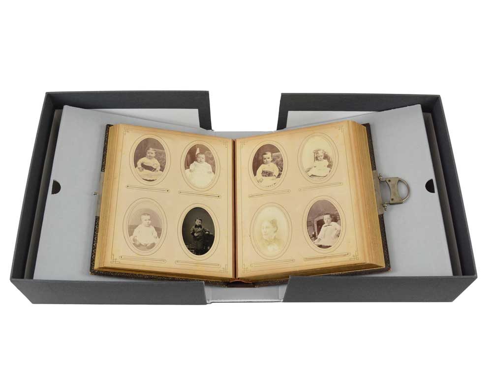 Rare Book Box with Cradle for fragile books, featuring a spine-supporting cradle holding an open photo album in an archival box.