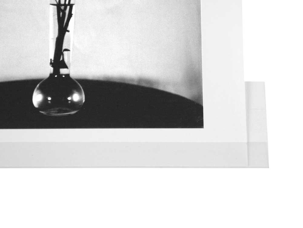 Archival-quality clear print mounting strips with self-adhesive backing, securely holding artwork in place without direct contact with adhesive.