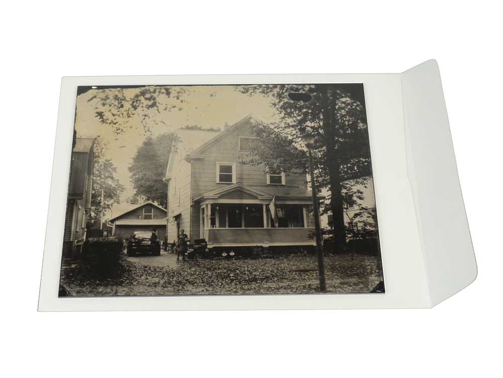 Acid-free Flap Envelope with a photograph on top to check fit, providing safe, long-term storage for museums, collectors, and archives.
