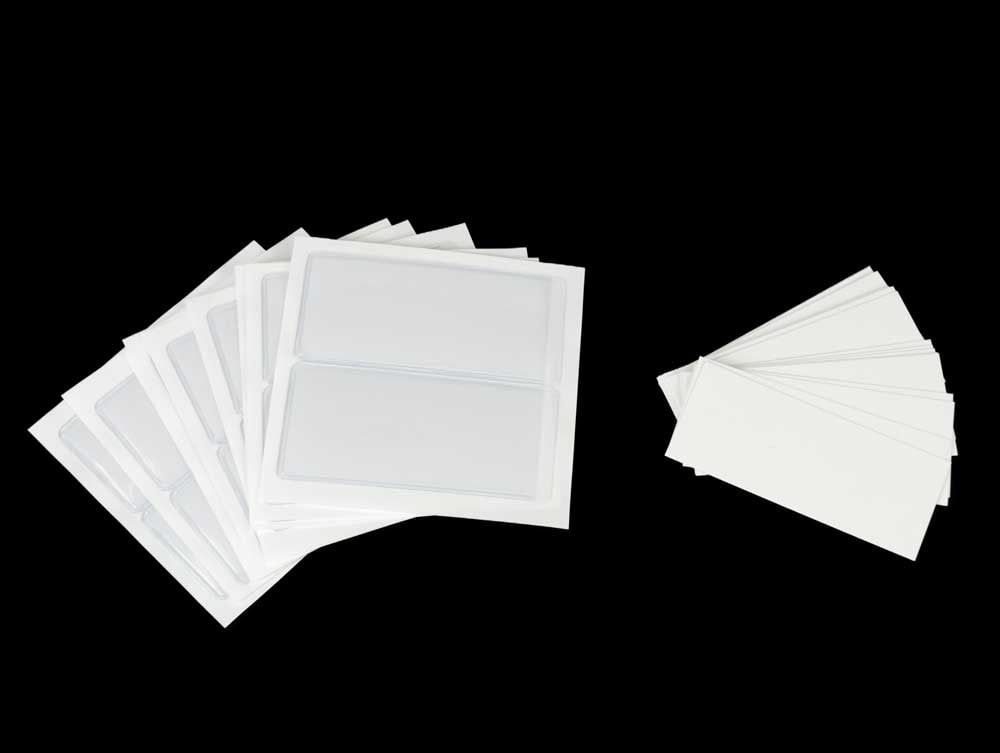 Transparent adhesive vinyl label holders securely attached to a storage box, ensuring easy organization and clear identification of contents