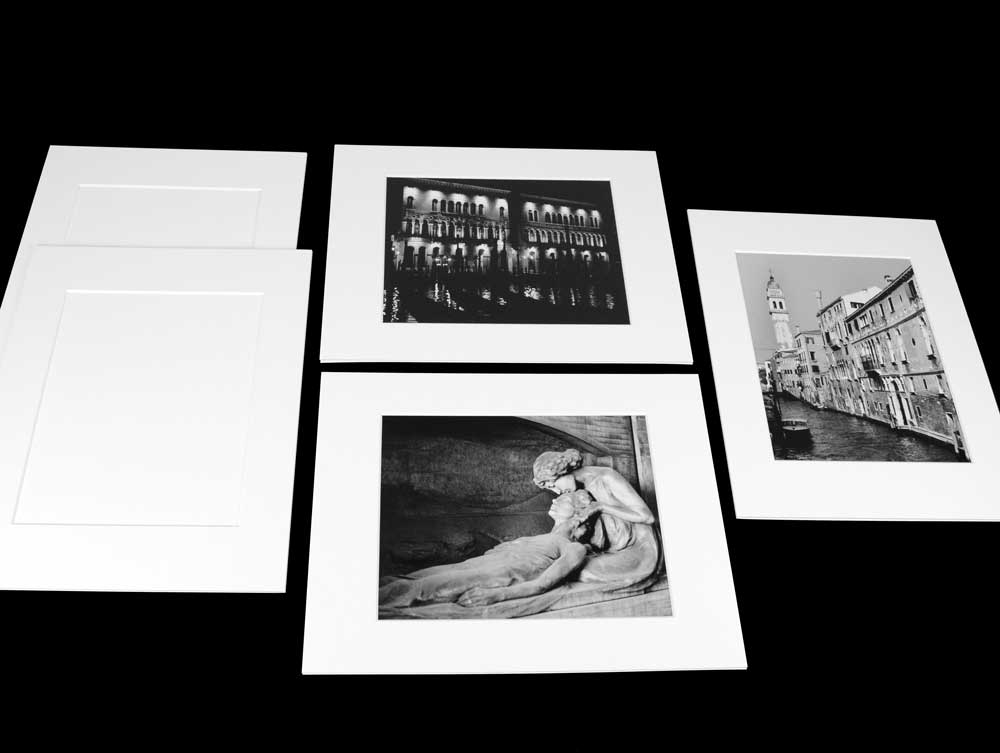 Photographs with pre-cut exhibition mats, 4-ply, acid-free board, offering archival protection with beveled windows and 2-ply backing.