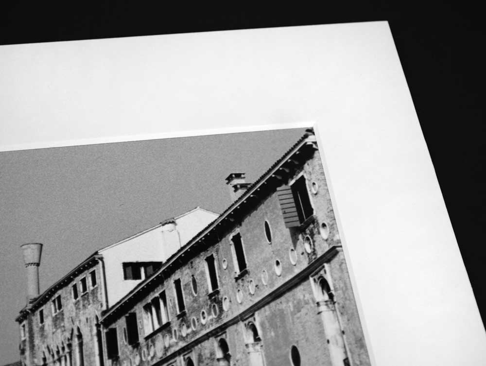 Photographs with pre-cut exhibition mats, 4-ply, acid-free board, offering archival protection with beveled windows and 2-ply backing.