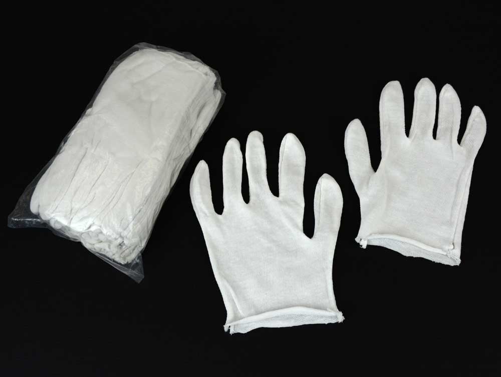 White cotton inspection gloves protect photographs and artifacts from oils and fingerprints during handling and archival care. 