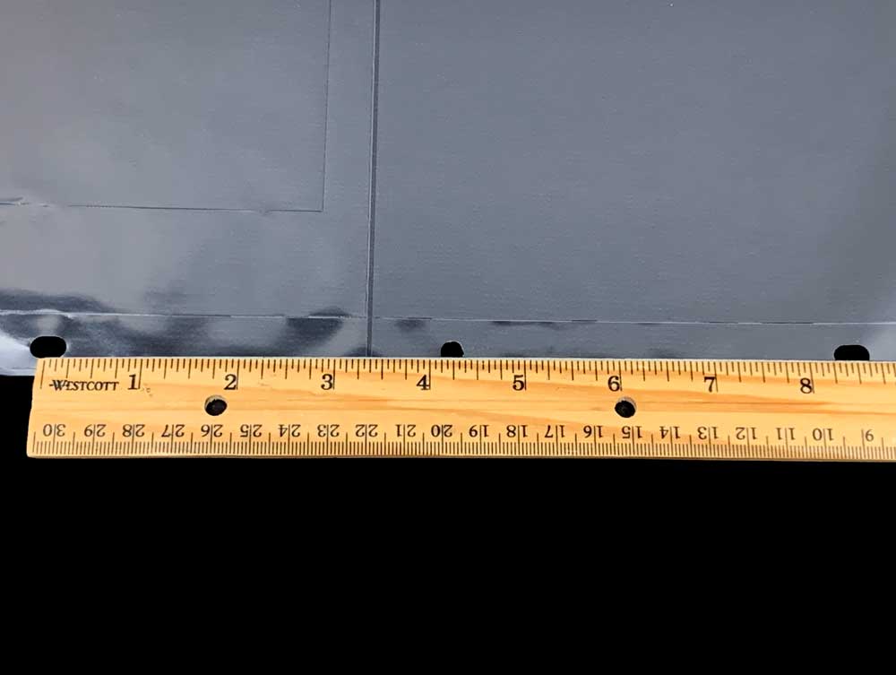 Ruler showing distance of holes on our archival 3-ring binder pages.