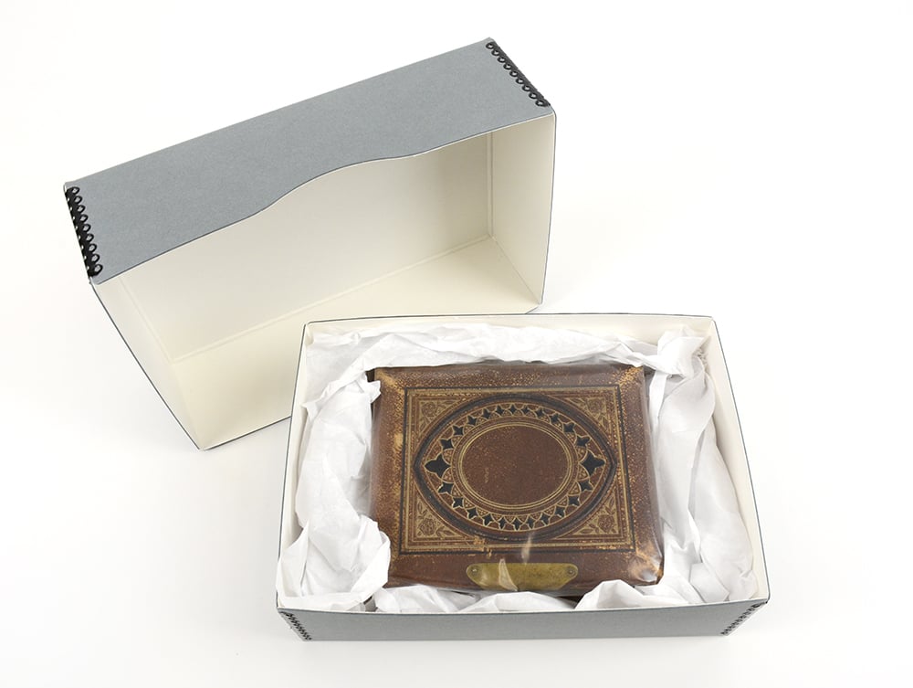 Archival gray Full Top Box made from acid-free materials, holding a large Bible cushioned with acid-free tissue for support
