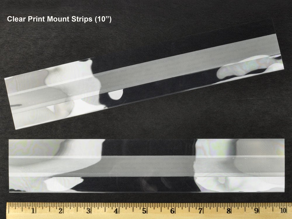 Archival-quality clear print mounting strips with self-adhesive backing, securely holding artwork in place without direct contact with adhesive.