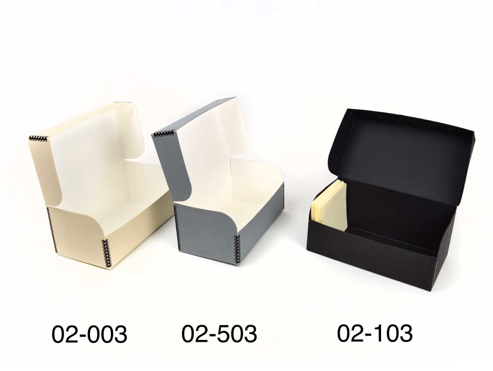 Three archival Hinged Lid Boxes made from acid-free materials, with tops open showing tan, gray, and black options.