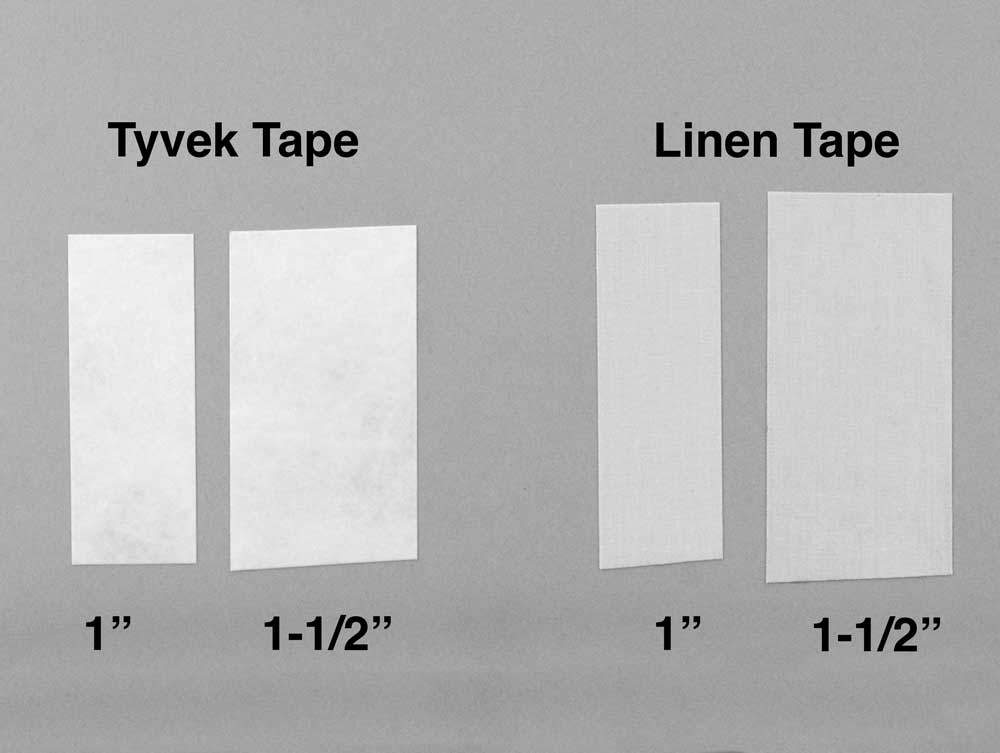 Close-up of one inch and one-half inch of acid-free linen tape and Tyvek tap used for  for hinging window mats and bookbinding.