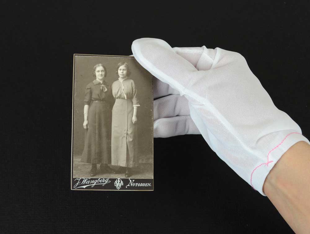 Nylon Lintless inspection gloves protecting documents and artifacts from fingerprints, ideal for delicate handling and archival care. 