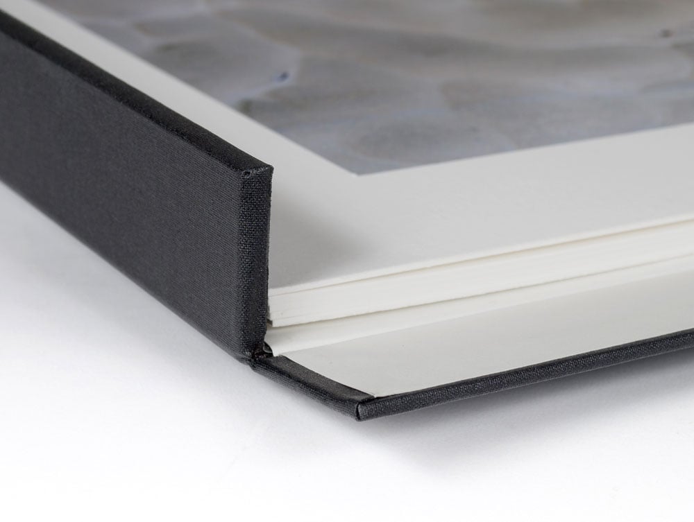 Close up of Museum Drop Front Box with matted artwork in the archival storage box, made from acid-free materials with a drop-front design for accessing artwork. 