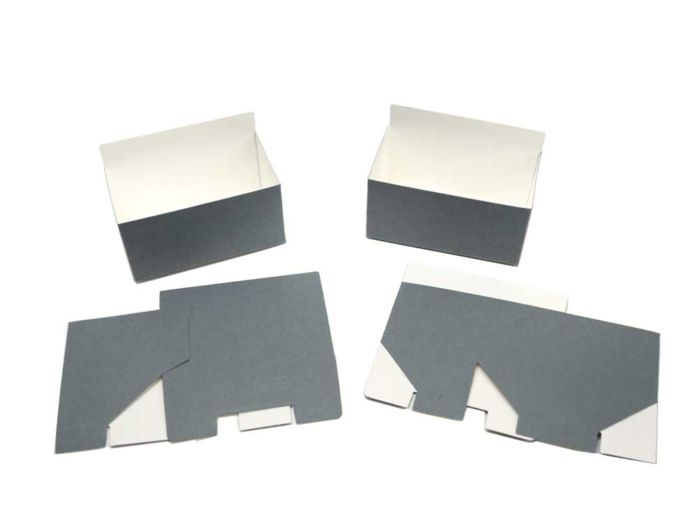 Showing the archival print organizing caddies flat and assembled for use in the kit. 
