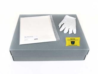 Textile Storage Kit with an acid-free box, tissue paper, cotton gloves, and desiccant for preserving quilts and delicate fabrics.