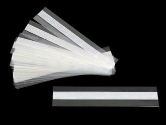 Archival-quality clear print mounting strips with self-adhesive backing, securely holding artwork in place without direct contact with adhesive. 